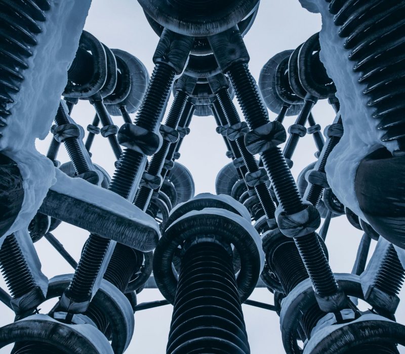 A dramatic view of a snow-covered industrial power tower in Moscow, Russia.