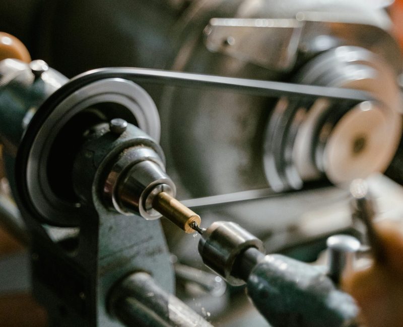 Detailed image of a metalworking machine tool with drill in action in an industrial setting.